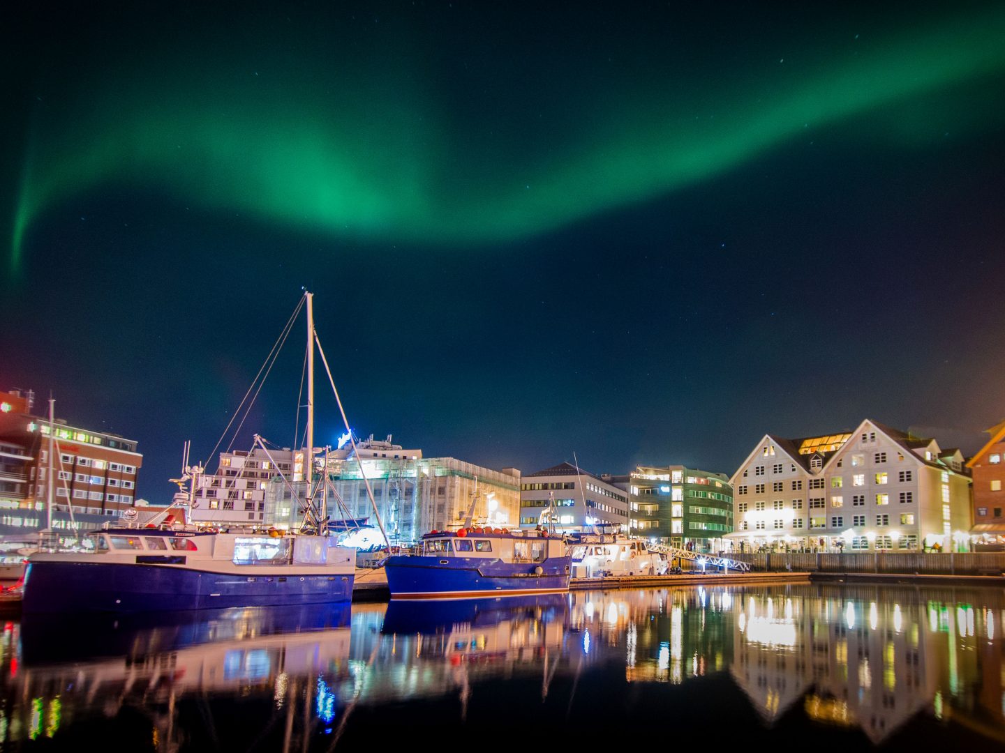 Northern lights (Aurora Borealis) above harbour of Troms&oslash;, Norway