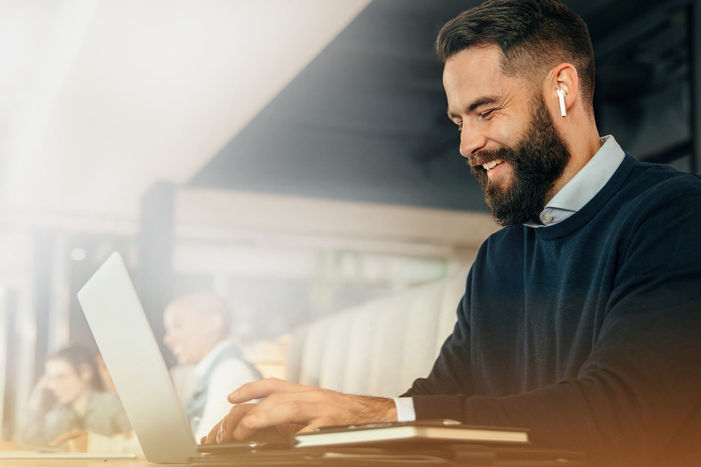 Travel manager with black hair is working on a computer and is using BusinessToGo