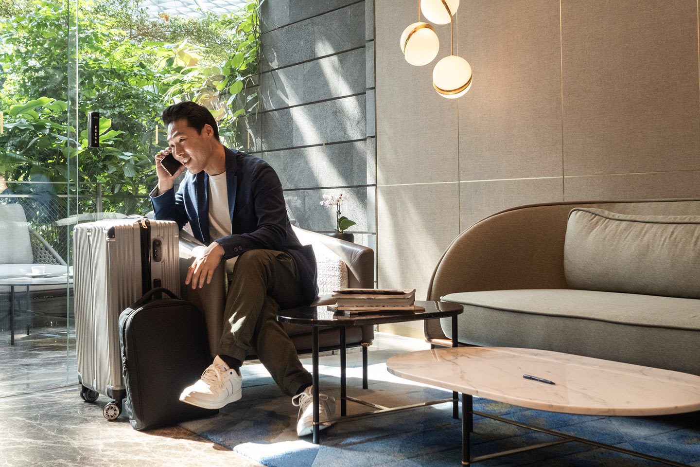 Traveler with black hair talking on a mobile device