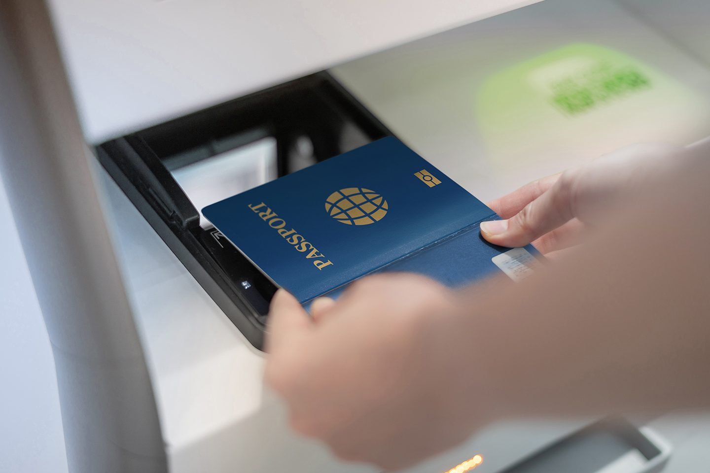 Female hand holding personal passport scanning at the self service checkin counter for get boarding pass at the airport terminal.