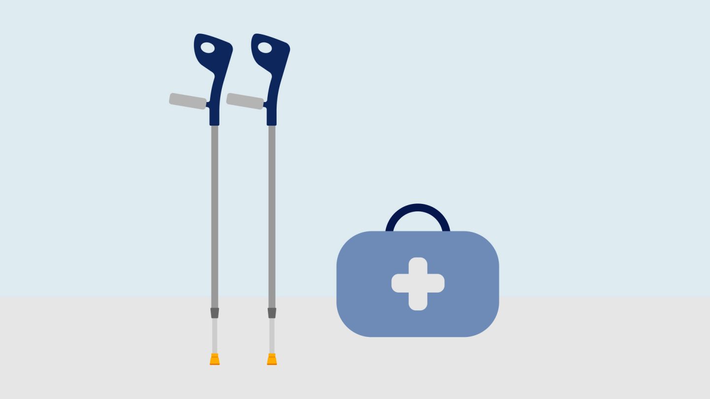 A first aid kit next to crutches, illustrating the combination of mobility aids and healthcare supplies.